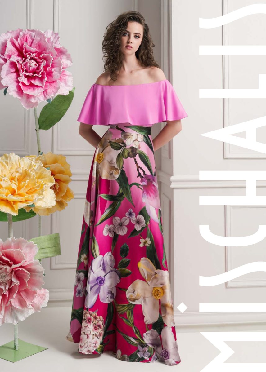 Conjunto de fiesta de Mischalis con top fucsia de hombros descubiertos y volante, y falda larga amplia con estampado floral multicolor.